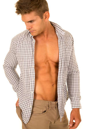 a man with his shirt unbuttoned showing off his chest.の写真素材