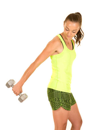 a woman doing her tricep extension working out her arms with weights.の写真素材