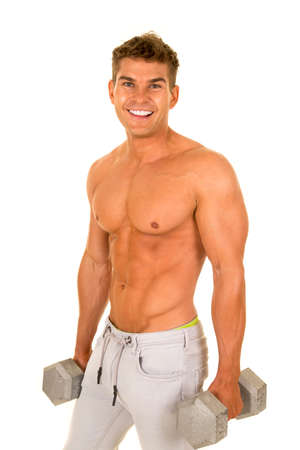 A man without his shirt on holding on to his weights.の写真素材