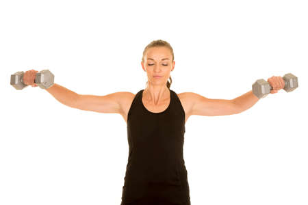 A woman with her eyes closed, doing a lat raise.の写真素材
