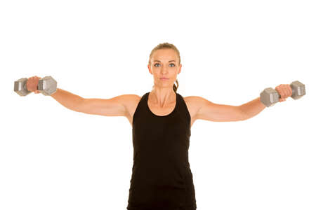 A woman doing a lat raise with weights.の写真素材