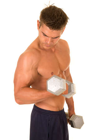 A man working out with weights flexing his arms.の写真素材