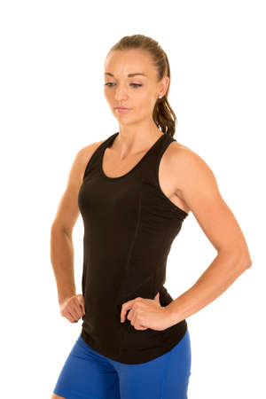 a woman in her fitness clothing looking down posing.の写真素材