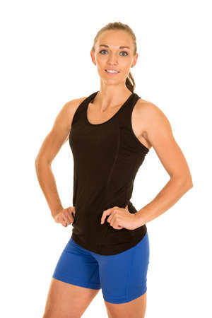 A woman in her fitness clothing posing with a smile.の写真素材