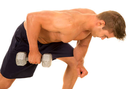 a shirtless man working on his tricep with a weight.の写真素材