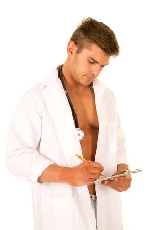 A Doctor with his clipboard looking down and taking notes.の写真素材