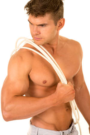 A man without his shirt on with a rope across his muscular chest.の写真素材