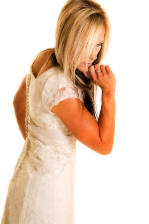 a bride in her wedding dress looking down.の写真素材