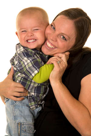 A pregnant woman with her little boy giveing a big hug with a big smile.の写真素材