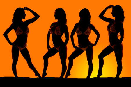 A silhouette of a woman in different positions in the outdoors.の写真素材