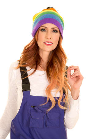 A woman in her winter purple coveralls and colorful beanie.の写真素材