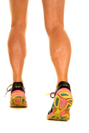 A woman's very fit legs with her shoes on flexing her calf muscles.の写真素材