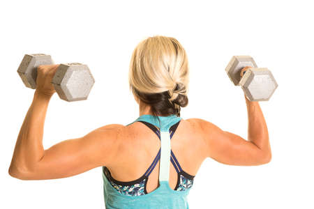 A woman in her fitness clothing working out with weights.の写真素材