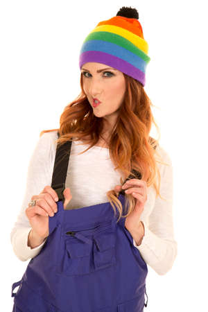 A woman in her colorful beanie and ski coveralls.の写真素材