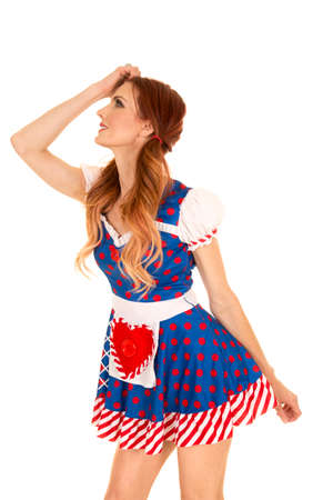 a woman in her costume with her hand up to her head.の写真素材