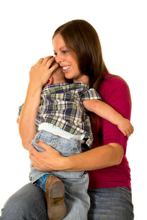 A pregnant woman holding on to her toddler with a smile.の写真素材