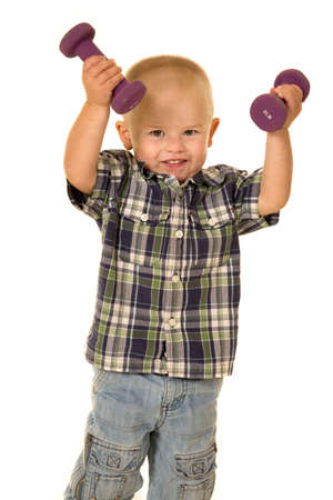 a young boy working out with weights, wanting to be healthyの写真素材