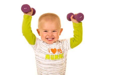 A young boy with a big smile, lifting up his weights.の写真素材