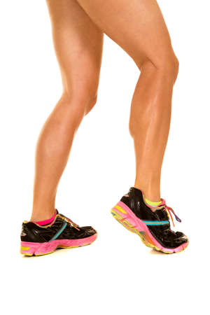 A woman's fit legs walking away in her shoes.の写真素材