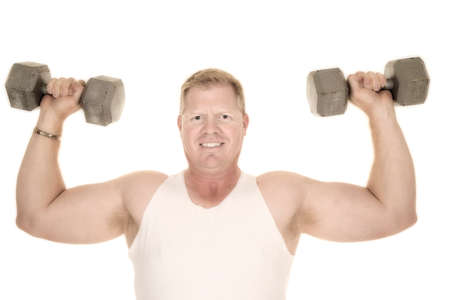 a man working out his shoulders with weights.の写真素材