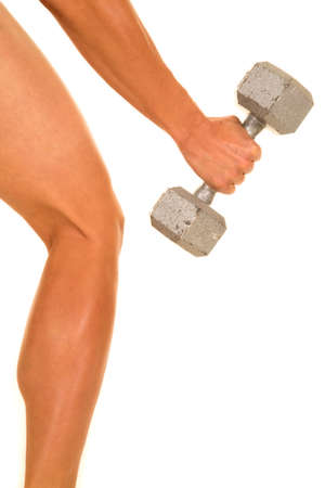 a woman with a weight in her hand next to her leg.の写真素材