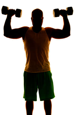 A silhouette of a man working out his shoulders, doing shoulder presses with weights.の写真素材