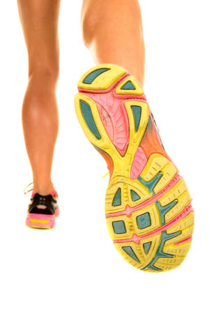 a woman's legs walking away showing her calf muscles and shoes.の写真素材