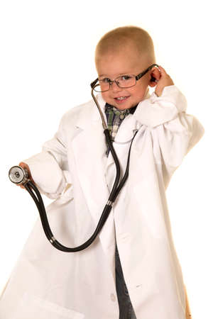 A young boy in his lab coat, with listening to something with his stethoscope.の写真素材