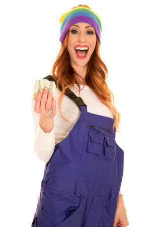 A woman in her purple ski coveralls and with a shocked expression, holding out money.の写真素材