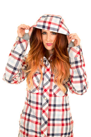 A woman in her ski coat, with the hood on her head.の写真素材