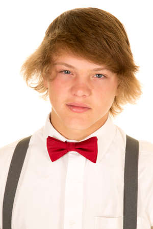 A teen in his white shirt and bow tie with a serious expression.の写真素材