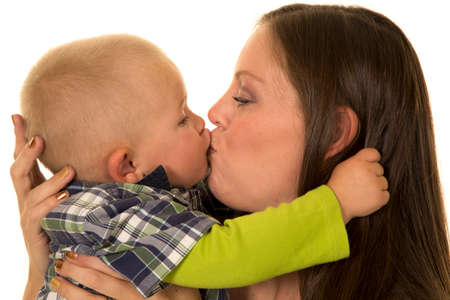 A woman giving her little boy a kiss.の写真素材