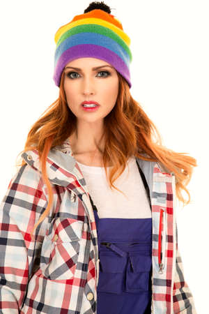 A woman in her ski bib's , colorful beanie and winter coat with a serious expression.の写真素材