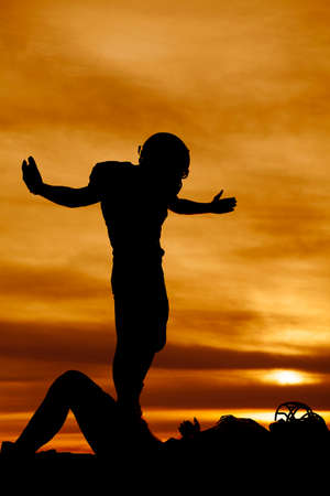 A football player showing some attitude after tackling another player.の写真素材