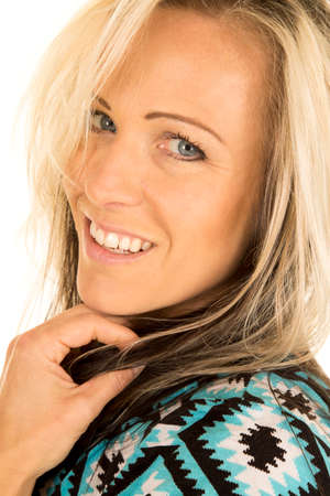 A woman with a big smile looking over her shoulder.の写真素材