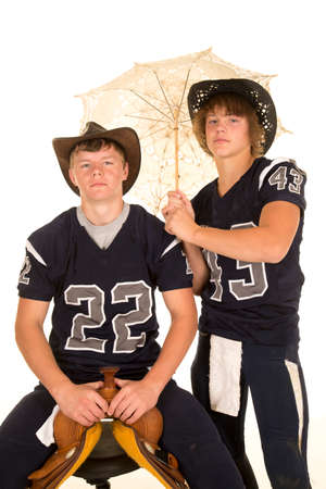 Two football teenagers with their western hats and cowboy hats.の写真素材