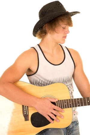 A young cowboy playing his guitar in his western clothes.の写真素材