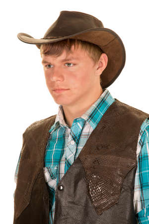 A young man in his western vest and hat, with a serious expression on his face.の写真素材