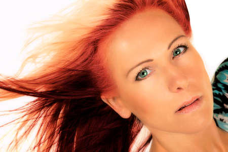 A close up of a woman with her hair blowing in the wind.の写真素材