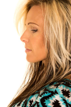 A blonde woman with a side view of her face.の写真素材