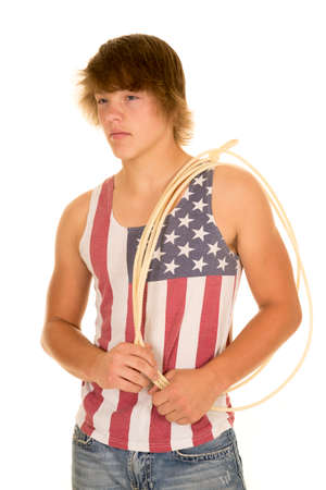 A young man in his tank with his western rope on his shoulder.の写真素材
