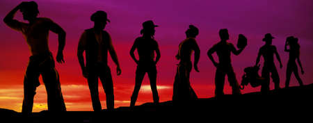 A silhouette of many cowboys and their cowgirls in a row.