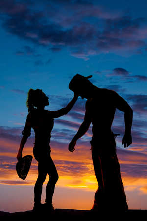 A cowgirl touching her cowboys head showing her compassion.の写真素材