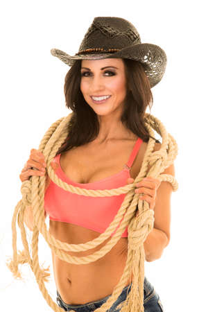 A sexy woman in a cowgirl outfit holding a rope.の写真素材