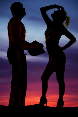 A silhouette of a woman with her cowboy.の写真素材