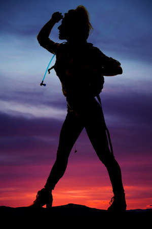 a woman hiker with her pack on looking out in the distance.の写真素材