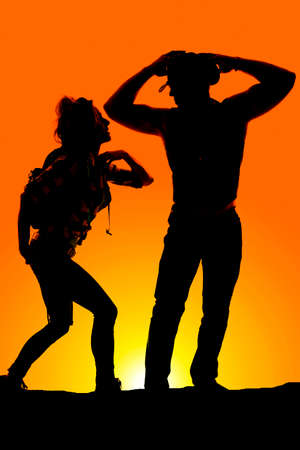 A silhouette of a woman hiker with her man taking a break from the hike.の写真素材