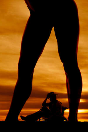A silhouette of a woman's legs you can see her cowboy in between them.の写真素材
