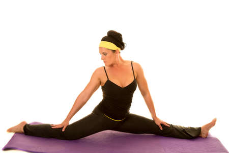 A woman in her fitness clothing doing the splits.の写真素材