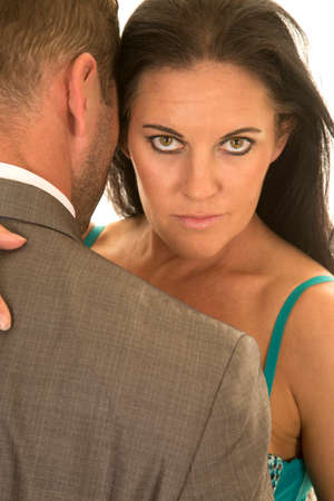 A couple close together her looking over her man's shoulderの写真素材